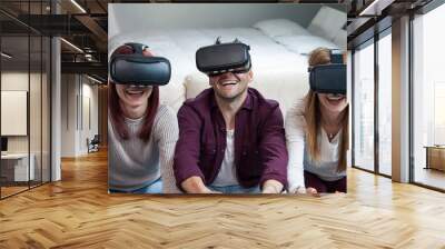 Young happy three friends playing video games virtual reality glasses Wall mural