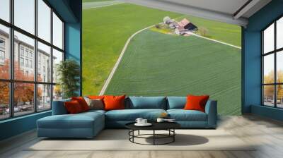 Aerial view of farm house in remote area in rural landscape in Switzerland. Wall mural