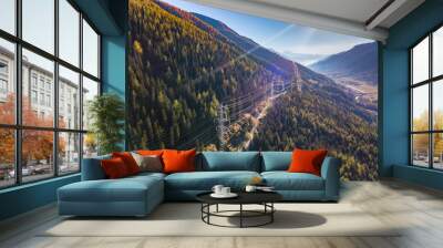 Aerial view of power line pylon in mountaineous area in Switzerland through valley in Canton of Valais Wall mural