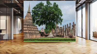 Buildings and stone Buddha symbol at Sukhothai Historical Park in Thailand Wall mural