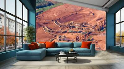 aerial view of a Bauxite Mine with massive equipment and machines, the surrounding earth surface is orange Wall mural