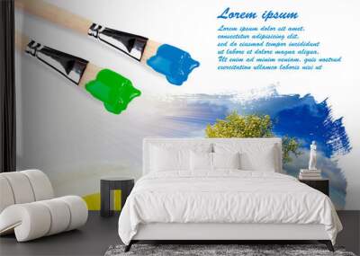 two paintbrushes and a landscape painting with copyspace Wall mural