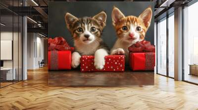 Cute little kittens with gift boxes on wooden table on dark background Wall mural