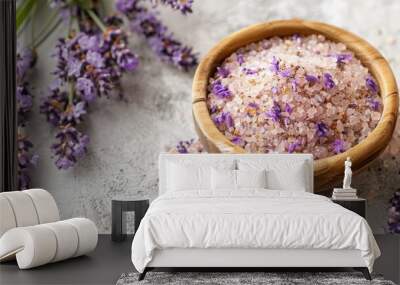 Beautiful wooden bowl containing aromatic lavender infused bath salts, adorned with vibrant lavender flowers, offering a relaxing and soothing spa atmosphere. Wall mural