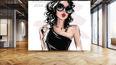 Hand drawn beautiful young woman in sunglasses. Stylish girl with bow on her head. Fashion woman look. Sketch. Vector illustration. Wall mural