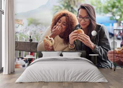 This is the best place in town. Cropped shot of a friends eating burgers outdoors. Wall mural