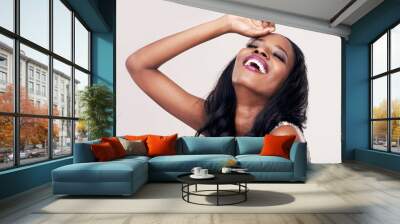 Beauty, laughing and face of a black woman in studio for makeup, eyelash or hair extension. Happy african female aesthetic model on a white background for cosmetics, skin glow and luxury skincare Wall mural