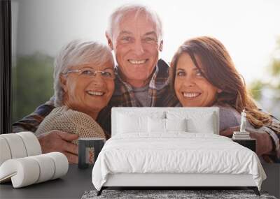 My pride and joy. A cropped portrait of a happy senior couple and their adult daughter at home. Wall mural