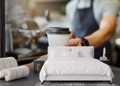 Coffee to go in hand of barista in coffee shop Wall mural