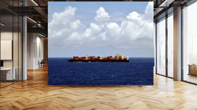 Cargo container ship sailing through the calm, blue sea. Wall mural