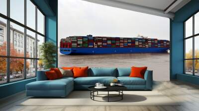 Fully loaded with boxes, large container ship is arriving to the port of Shanghai, China.  Wall mural