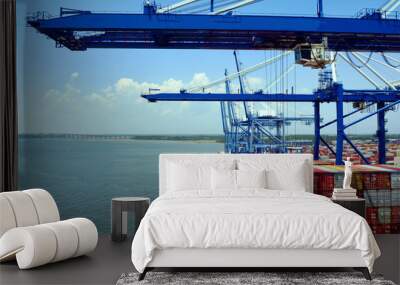 Gantry cranes are loading cargo on the container ship in port of Charleston, South Carolina.   Wall mural