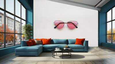 Pink sunglasses on beige paper background. Warm colors and shades Wall mural