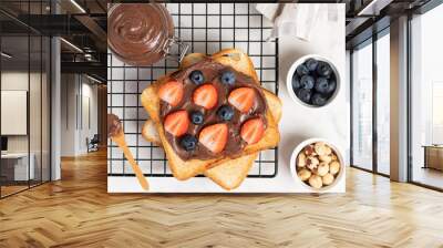 fresh toasts with chocolate paste and berries serve on table for delicious breakfast Wall mural