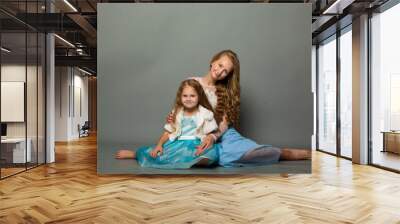 Two cute girls on a gray background Wall mural