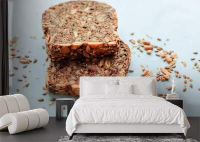 Sliced whole grain bread rye with seeds flax, sunflower, pumpkin and sesame.Healthy food, eco-friendly natural products. Fresh bread on a pink background. Wall mural