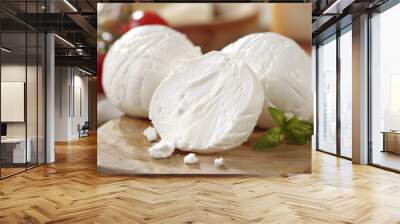 Large balls of Italian mozzarella di Bufala Campana on a chopping board with tomatoes and basil. Wall mural