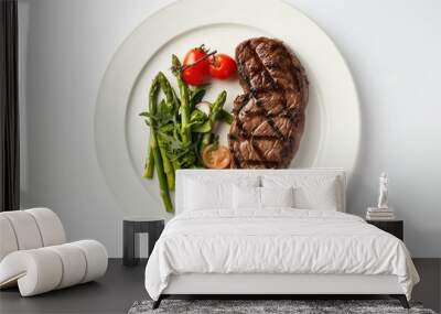 steak with vegetables on a white plate witn asparagus and tomatoes on a white background top view. protein food with vegetables Wall mural