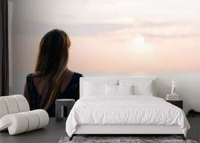 Young woman enjoying sunset on the beach Wall mural