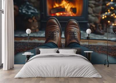 Closeup of leather shoes resting near a warm, cozy fireplace during winter. Relaxing atmosphere with holiday decorations and glowing fire in a comfortable living room. Wall mural