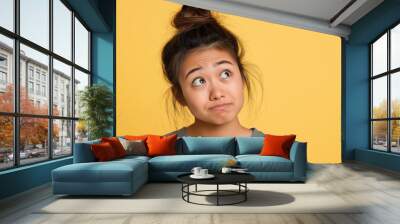 A studio close-up portrait of a young Asian woman wearing a casual t-shirt, with a colourful background. Wall mural