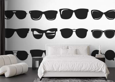 Illustration of a black cartoon silhouette of sunglasses isolated on a white background. Wall mural