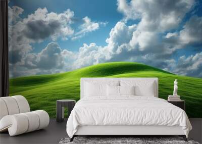 Lush green hill under a cloudy blue sky. Wall mural