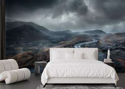 Moody, volcanic landscape with winding road under stormy skies. Wall mural