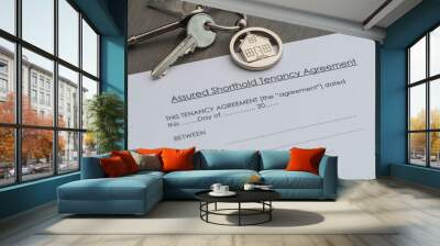 Real estate rental tenancy agreement on a table with keys and house keyring. New home concept. Wall mural