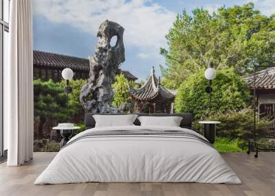 Giant rock in garden by Chinese architecture at Lingering Garden Scenic Area, Suzhou, Jiangsu, China Wall mural