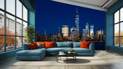 Night view of skyline of downtown Manhattan over Hudson River under dark blue sky, in New York City, USA Wall mural