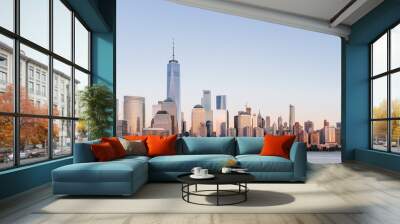 Skyline of downtown Manhattan over Hudson River under blue sky, at sunset, in New York City, USA Wall mural