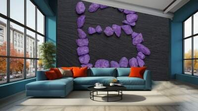 Letter B made from purple rocks on a dark background. Wall mural