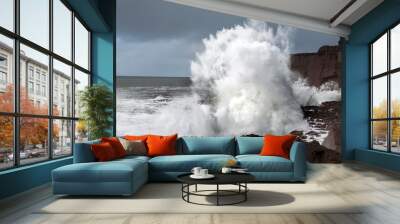 Power full ocean wave breaks on rock shore line creating big splash of water. Storm on West coast of Ireland. Power of Nature concept. Wall mural