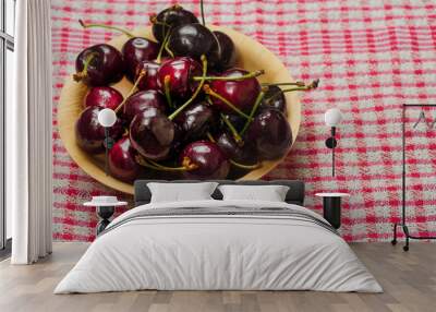 Red fresh juice cherry in a wooden bowl on a red and white table cloth. Close up. Fresh berries. Food industry. Produce product Wall mural