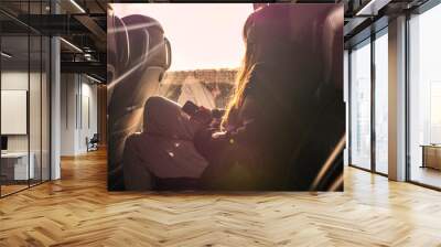 Teenager girl looking into window and listening music on a trip in a bus. Travel and transportation concept. Selective focus. Wall mural