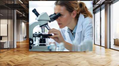 A female engineer using a microscope in a science lab Wall mural