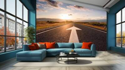  A straight road with an arrow painted on it leading to the horizon Wall mural