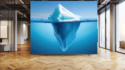  An iceberg visible above and below water on a clear blue background, illustrating the concept of hidden depth Wall mural