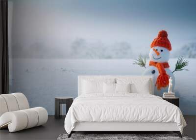  Cheerful snowman in a red hat and orange scarf standing in snowy winter landscape Wall mural