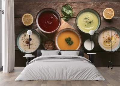  flat lay tasty broth and different cream soups in bowls on old wooden table Wall mural