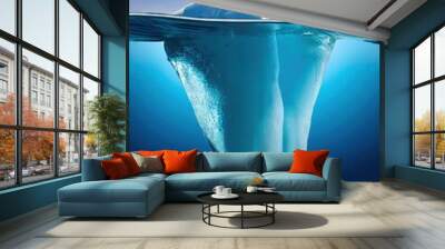 An iceberg visible above and below water on a clear blue background, illustrating the concept of hidden depth  Wall mural