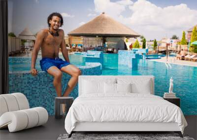 Beautiful young african american man at the swimming pool Wall mural