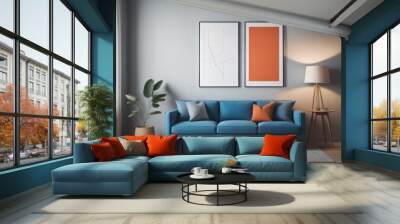 Blue sofa and terra cotta lounge chair against wall with two art posters Minimalist home interior design of modern living room  Wall mural