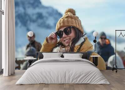 Close-up shot of a young girl in winter clothes standing in ski resort at Monte Lussari in Italy Wall mural