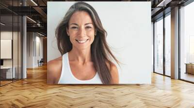 mature woman in TANK TOP , long hair smiling to the camera isolated on white background with copy space Wall mural