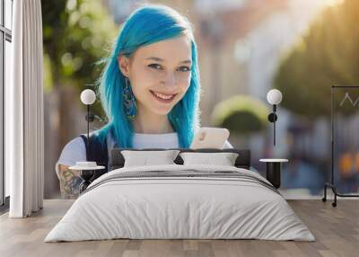 millennial female with blue hair and tattoos smiling using smartphone Wall mural