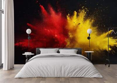 Red and yellow colored powder explosions on black background. Holi paint powder splash Wall mural