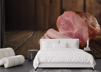 Sliced ​​smoked ham on wooden table  Wall mural