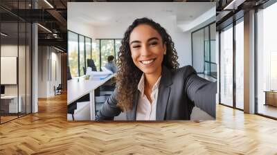 Smiling businesswoman taking a selfie in the office Wall mural